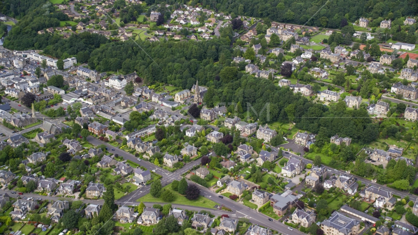 A residential neighborhood with church and trees, Stirling, Scotland Aerial Stock Photo AX109_057.0000000F | Axiom Images