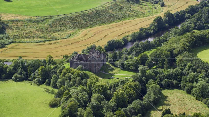 Historic Doune Castle and trees in Scotland Aerial Stock Photo AX109_066.0000000F | Axiom Images