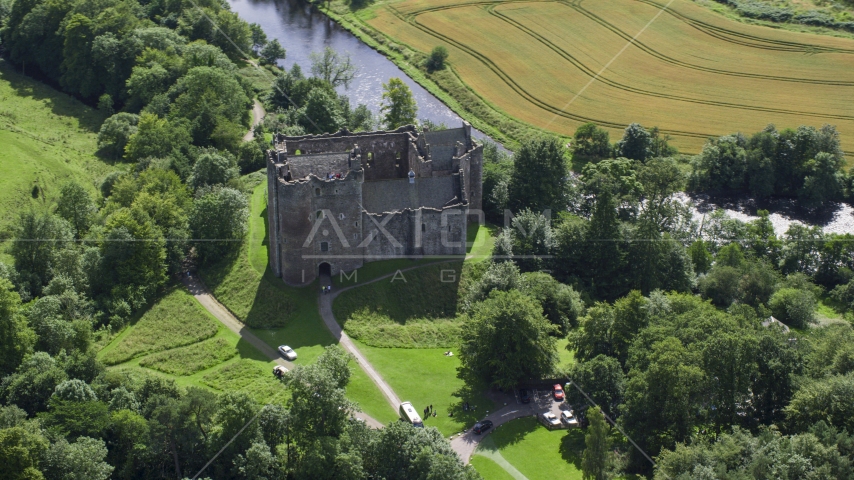 Iconic Doune Castle beside a river, Scotland Aerial Stock Photo AX109_068.0000000F | Axiom Images