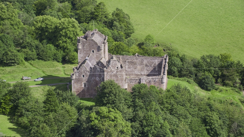 Iconic Doune Castle nestled in trees, Scotland Aerial Stock Photo AX109_070.0000000F | Axiom Images