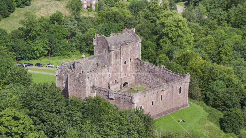 Doune Castle with tourists on the grounds, Scotland Aerial Stock Photo AX109_071.0000000F | Axiom Images