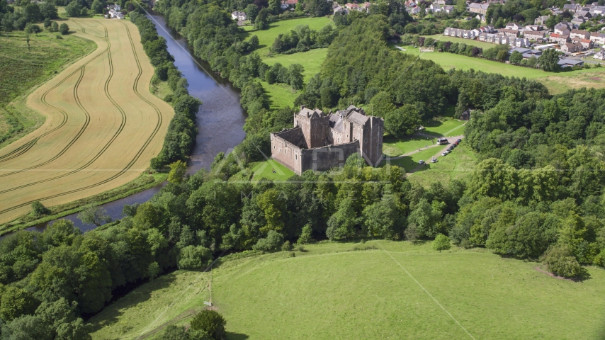 Doune Castle and River Teith among trees, Scotland Aerial Stock Photo AX109_075.0000000F | Axiom Images