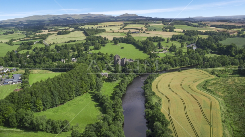 River Teith and historic Doune Castle near farmland, Scotland Aerial Stock Photo AX109_087.0000000F | Axiom Images