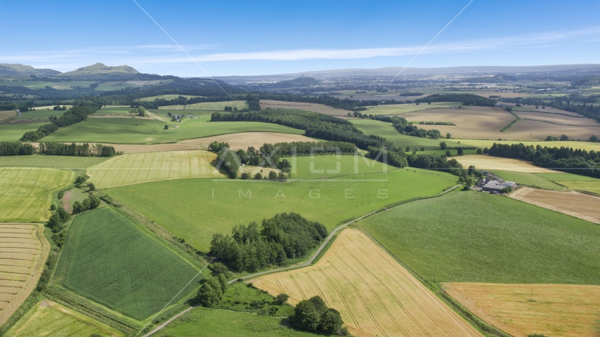 Farm and fields along a country road, Doune, Scotland Aerial Stock Photo AX109_089.0000000F | Axiom Images