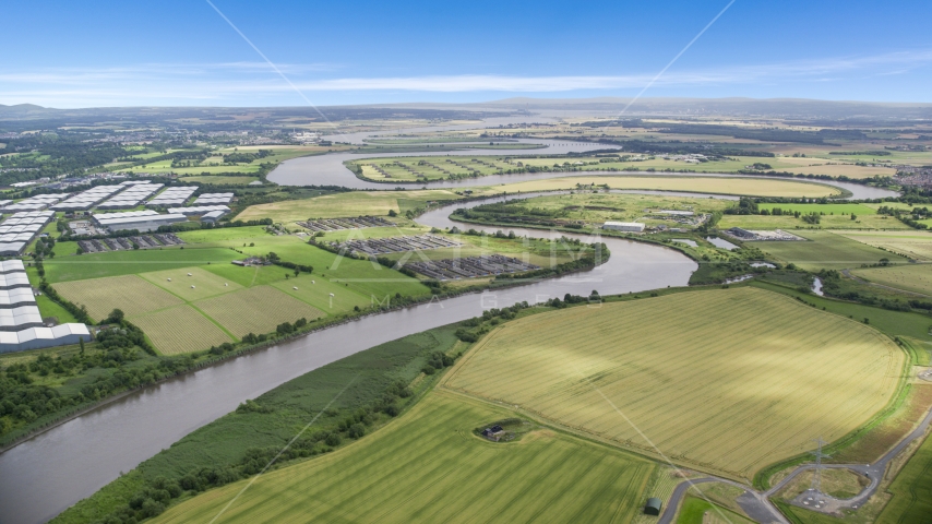 The River Forth near warehouses and green farm fields in Fallin, Scotland Aerial Stock Photo AX109_102.0000000F | Axiom Images