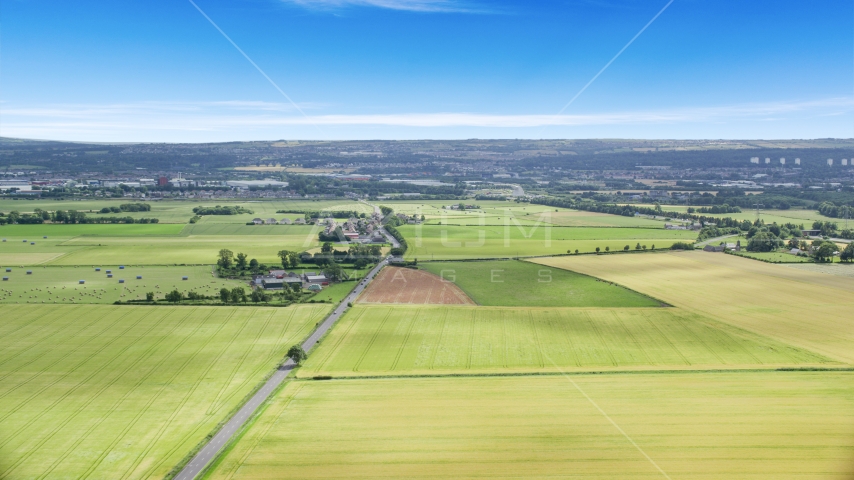 Farms and farm fields by A905 highway, Falkirk, Scotland Aerial Stock Photo AX109_116.0000115F | Axiom Images