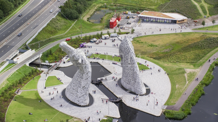 The backside of the iconic Kelpies sculptures, Falkirk, Scotland Aerial Stock Photo AX109_125.0000042F | Axiom Images