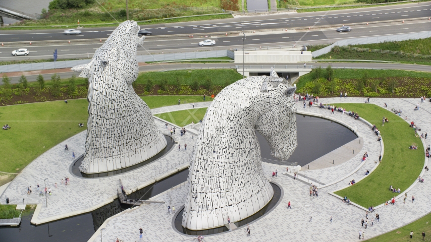 The iconic Kelpies sculptures in Falkirk, Scotland Aerial Stock Photo AX109_127.0000070F | Axiom Images