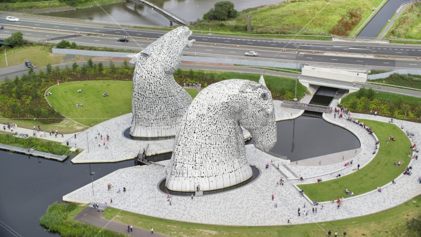 Profile view of The Kelpies sculptures in Falkirk, Scotland Aerial Stock Photo AX109_127.0000201F | Axiom Images