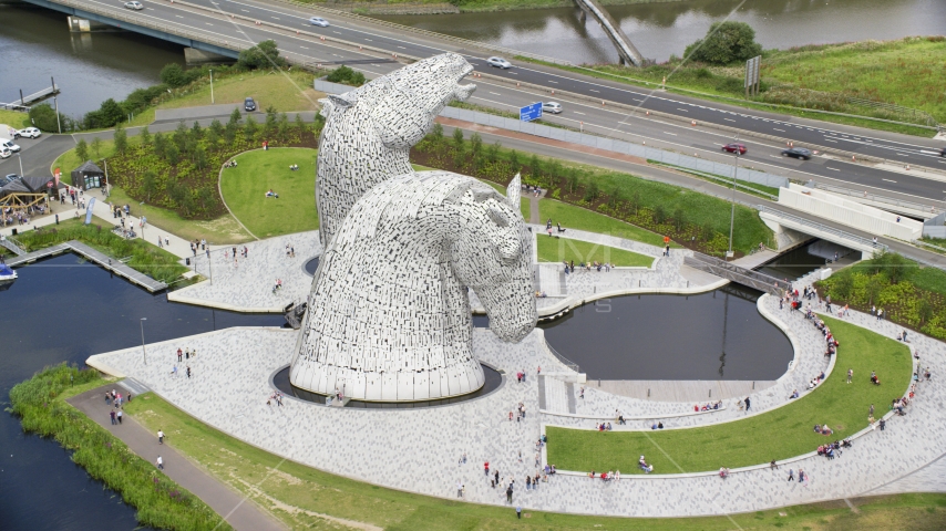The Kelpies sculpture in profile in Falkirk, Scotland Aerial Stock Photo AX109_128.0000103F | Axiom Images