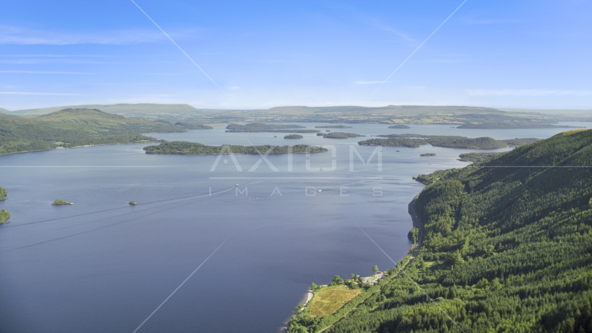 The blue waters of Loch Lomond and tiny islands, Scottish Highlands, Scotland Aerial Stock Photo AX110_104.0000000F | Axiom Images