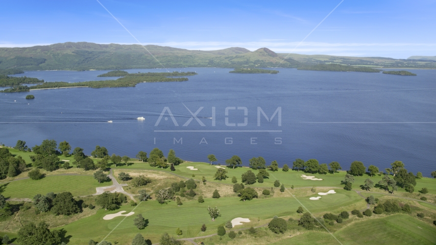 Waterfront Loch Lomond Golf Course in Luss, view of the lake, Scottish Highlands, Scotland Aerial Stock Photo AX110_118.0000098F | Axiom Images