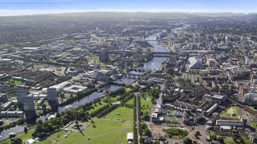 A wide view of River Clyde and bridges near city buildings in Glasgow, Scotland Aerial Stock Photo AX110_163.0000000F | Axiom Images