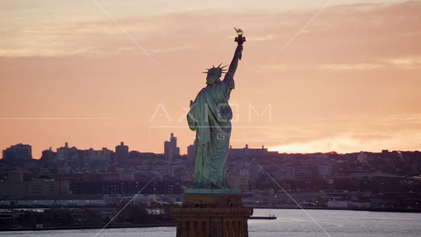 Back of the Statue of Liberty at sunrise, New York Aerial Stock Photo AX118_042.0000079F | Axiom Images