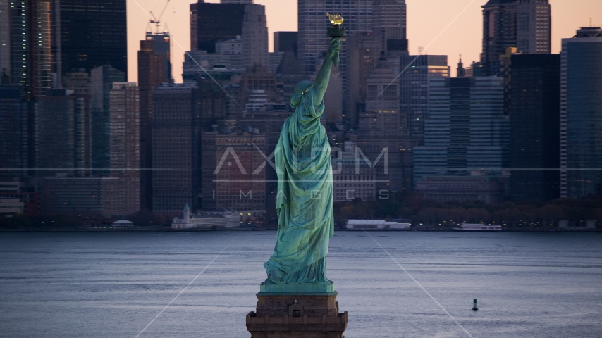 Statue of Liberty and Lower Manhattan skyscrapers at sunrise, New York Aerial Stock Photo AX118_045.0000075F | Axiom Images