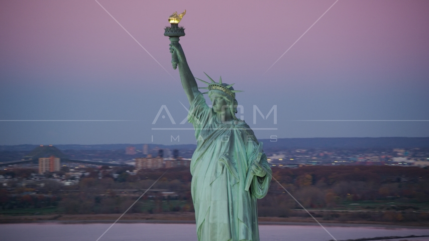 Statue of Liberty with purple sky at sunrise, New York Aerial Stock Photo AX118_050.0000000F | Axiom Images
