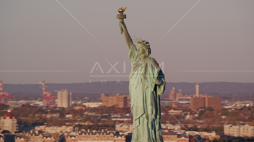 The front side of the Statue of Liberty at sunrise in New York Aerial Stock Photo AX118_104.0000067F | Axiom Images