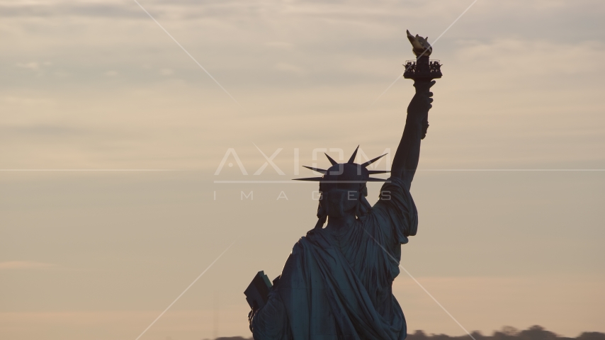 The back of the Statue of Liberty at sunrise in New York Aerial Stock Photo AX118_111.0000148F | Axiom Images
