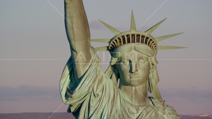 A close-up of the Statue of Liberty at sunrise in New York Aerial Stock Photo AX118_116.0000231F | Axiom Images