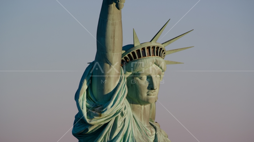 Close-up profile of the Statue of Liberty at sunrise in New York Aerial Stock Photo AX118_117.0000113F | Axiom Images