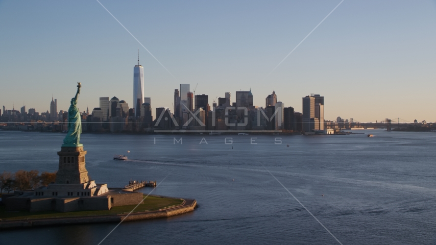 The Statue of Liberty and Lower Manhattan skyline at sunrise in New York Aerial Stock Photo AX118_122.0000202F | Axiom Images
