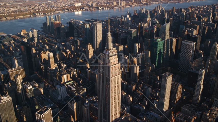 Empire State Building at sunrise in Midtown Manhattan, New York City Aerial Stock Photo AX118_181.0000135F | Axiom Images