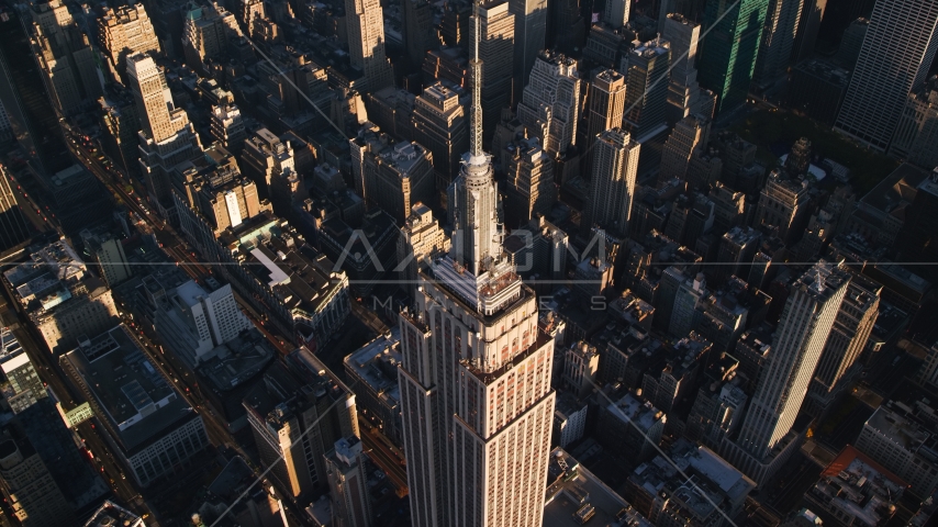 Empire State Building and spire at sunrise in Midtown Manhattan, New York City Aerial Stock Photo AX118_182.0000195F | Axiom Images