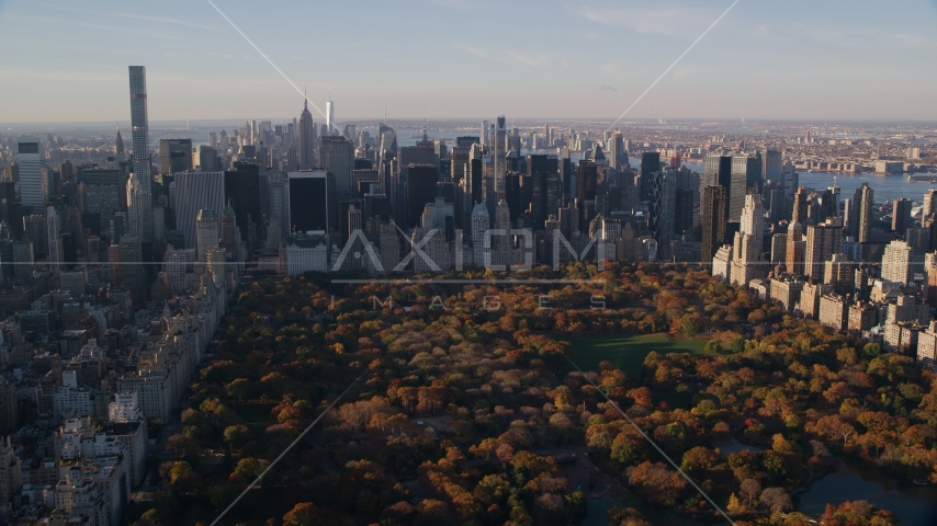 Central Park with autumn leaves and Midtown skyscrapers at sunrise in New York City Aerial Stock Photo AX118_194.0000000F | Axiom Images