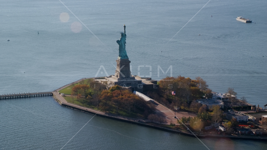 The back of Liberty Island and the Statue of Liberty in Autumn, New York Aerial Stock Photo AX119_013.0000083F | Axiom Images
