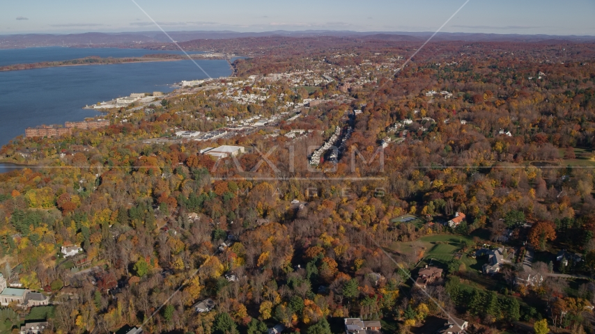 Upscale homes and small riverfront towns in autumn, Briarcliff Manor and Ossining, New York Aerial Stock Photo AX119_112.0000105F | Axiom Images