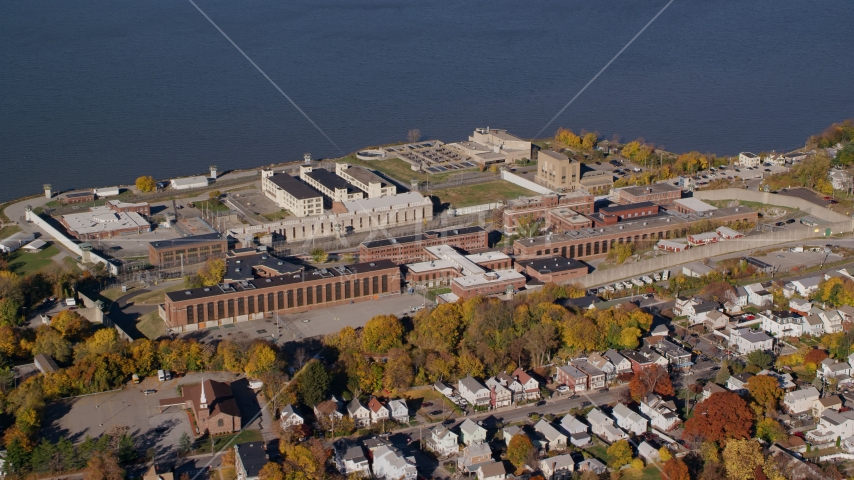 The riverfront Sing Sing Prison in Autumn, Ossining, New York Aerial Stock Photo AX119_114.0000130F | Axiom Images