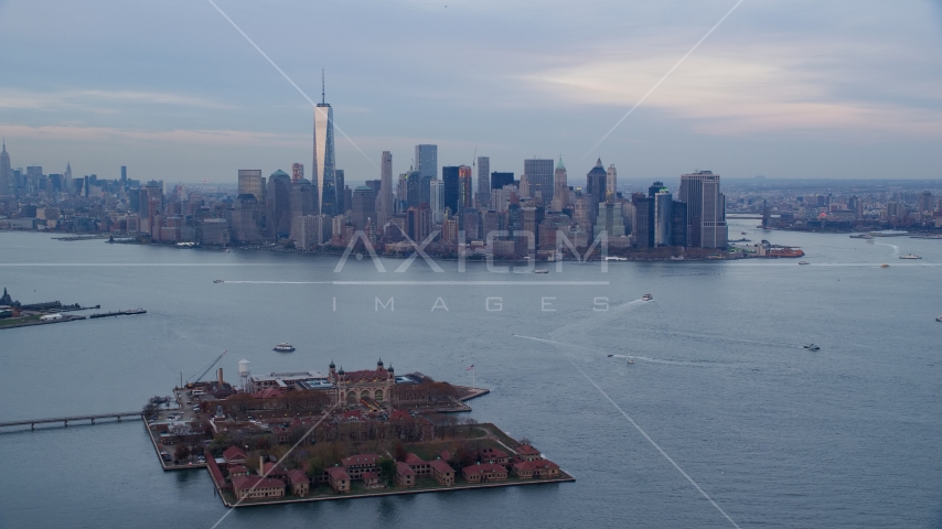 The Lower Manhattan skyline at sunset, New York City, seen from Ellis Island Aerial Stock Photo AX121_014.0000000F | Axiom Images