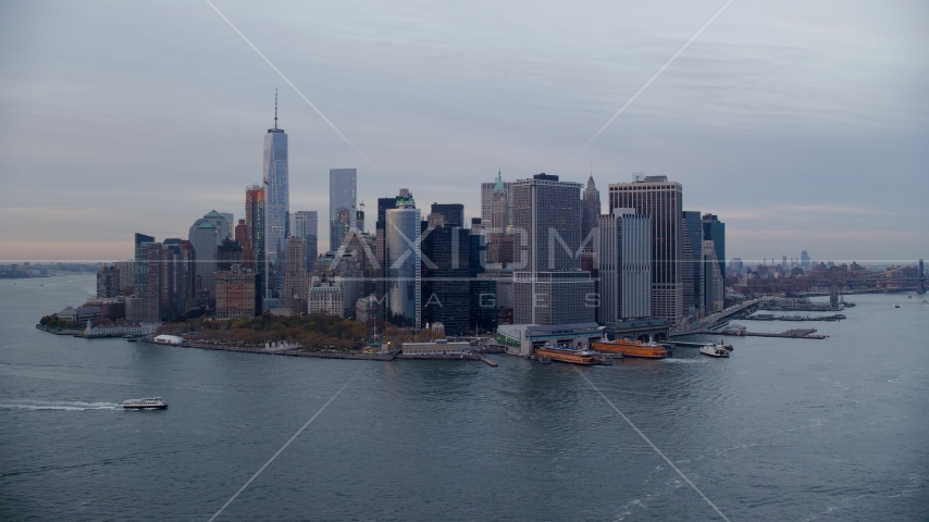 Battery Park, downtown skyline, and ferry terminal in Lower Manhattan at sunset, New York City Aerial Stock Photo AX121_019.0000105F | Axiom Images