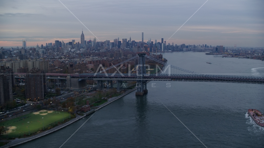 Lower East Side public housing, Williamsburg Bridge, and the Midtown skyline at sunset in New York City Aerial Stock Photo AX121_044.0000169F | Axiom Images