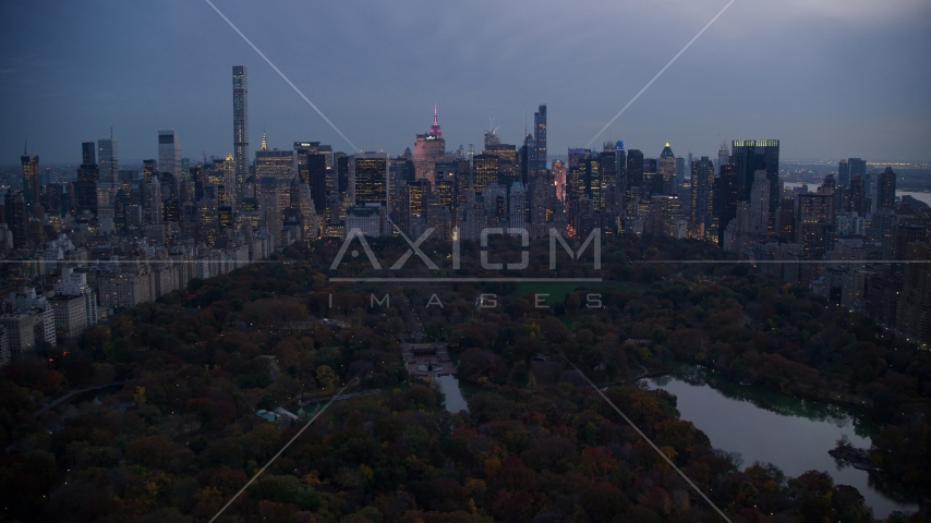 Midtown Manhattan skyscrapers and The Lake in Central Park at sunset, New York City Aerial Stock Photo AX121_098.0000265F | Axiom Images