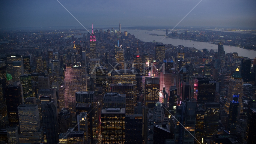 Midtown skyscrapers and bright lights of Times Square at sunset in New York City Aerial Stock Photo AX121_102.0000244F | Axiom Images