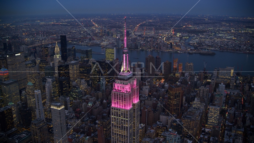 The Empire State Building with pink lights at sunset in Midtown, New York City Aerial Stock Photo AX121_108.0000414F | Axiom Images