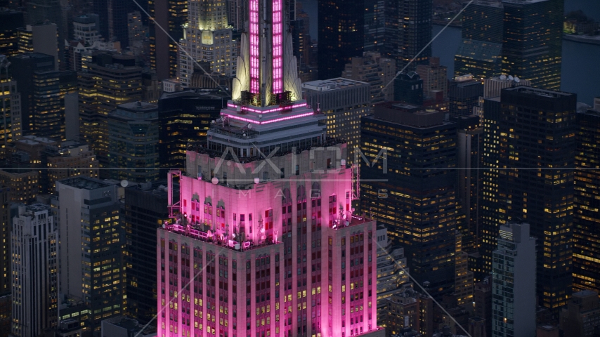 Empire State Building with pink lighting at sunset in Midtown Manhattan, New York City Aerial Stock Photo AX121_109.0000095F | Axiom Images