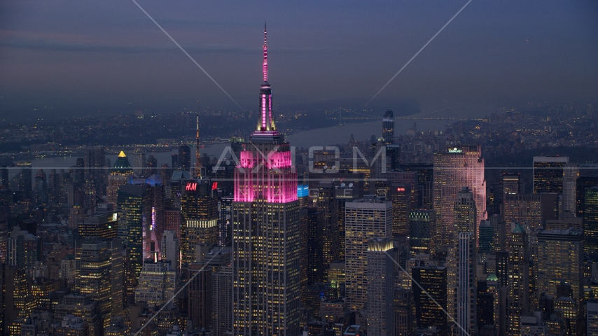 Pink lights on the Empire State Building at sunset in Midtown Manhattan, New York City Aerial Stock Photo AX121_111.0000100F | Axiom Images