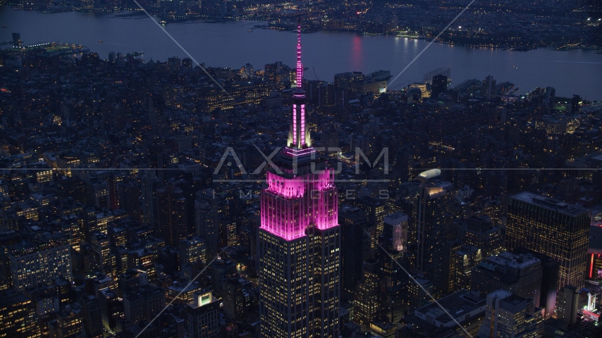 The Empire State Building with pink lights at sunset in Midtown, New York City Aerial Stock Photo AX121_127.0000132F | Axiom Images