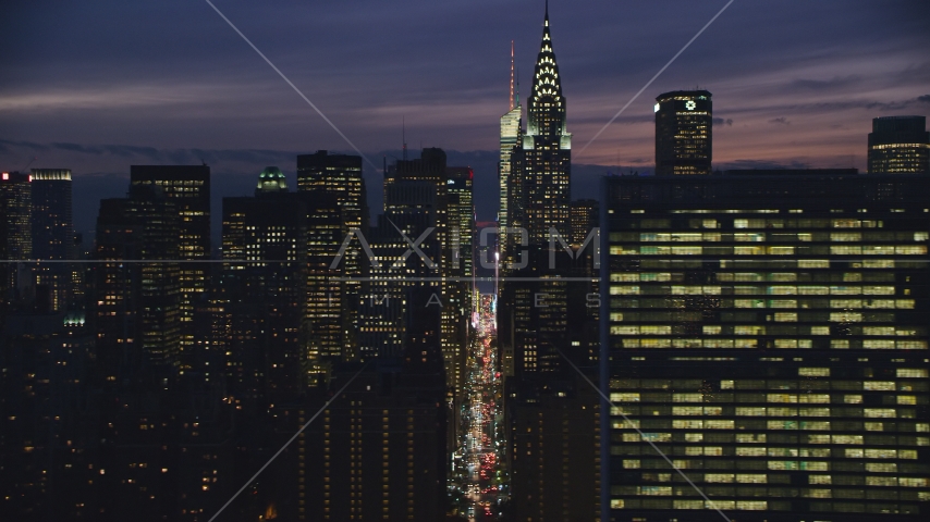 Midtown Manhattan city canyon by Chrysler Building and UN at night in New York City Aerial Stock Photo AX121_151.0000084F | Axiom Images