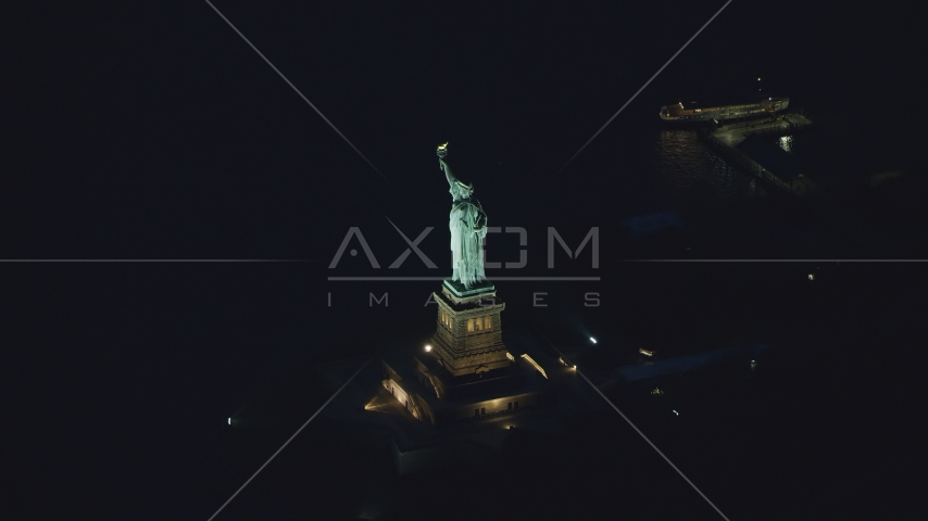 The Statue of Liberty at night in New York Aerial Stock Photo AX121_167.0000184F | Axiom Images