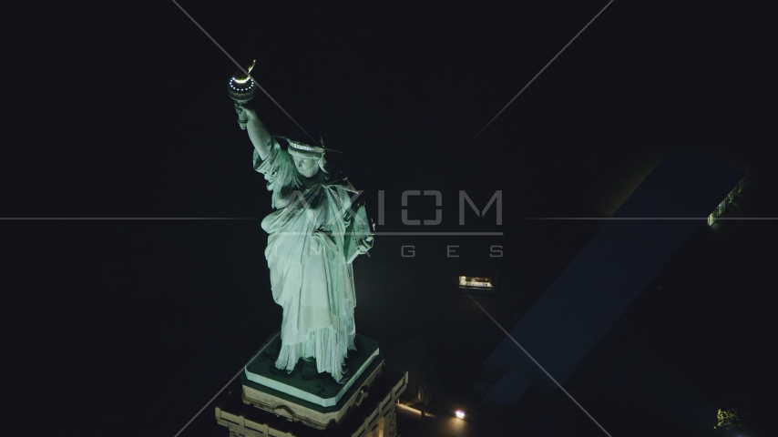 Statue of Liberty at nighttime in New York Aerial Stock Photo AX121_168.0000211F | Axiom Images