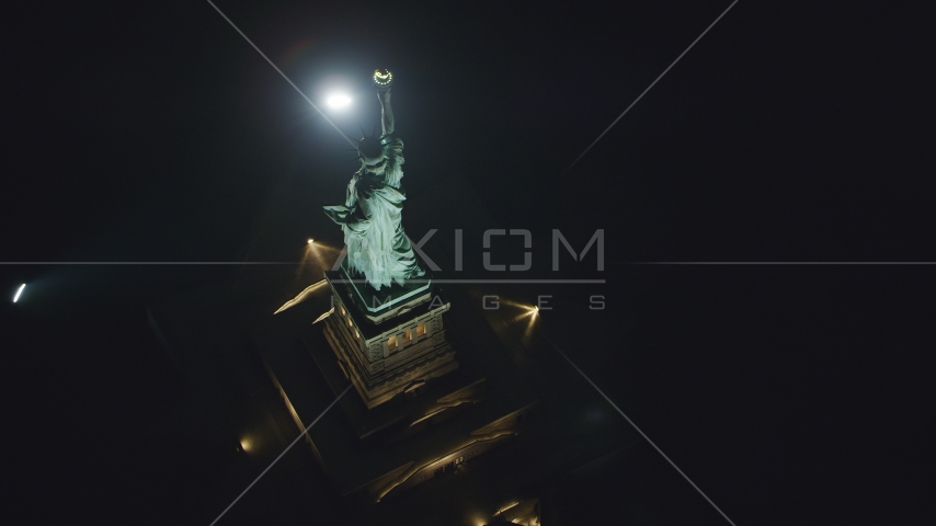 A bird's eye view of the back of the Statue of Liberty at night in New York Aerial Stock Photo AX121_196.0000108F | Axiom Images