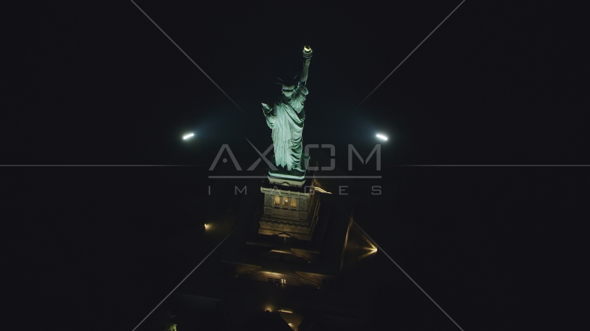 A bird's eye of the Statue of Liberty at nighttime in New York Aerial Stock Photo AX121_196.0000217F | Axiom Images