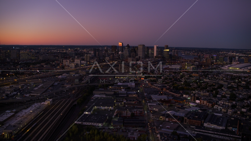 The city skyline, streets, and skyscrapers of Downtown Boston, Massachusetts, twilight Aerial Stock Photo AX141_016.0000000 | Axiom Images
