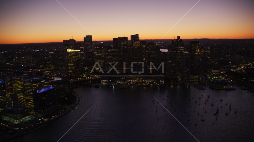 The city skyline, boats in the harbor in Downtown Boston, Massachusetts, twilight Aerial Stock Photo AX141_042.0000195 | Axiom Images