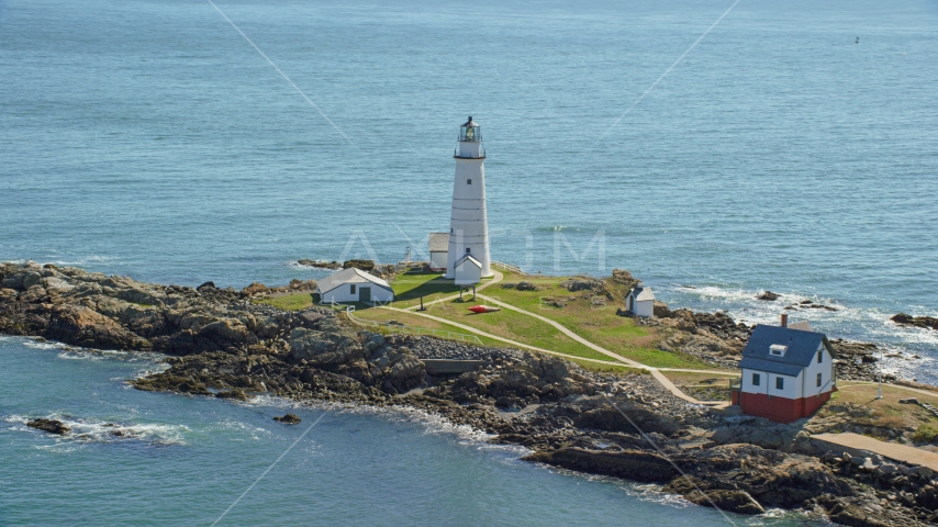 The Boston Light overlooking the water on Little Brewster Island, Boston Harbor, Massachusetts Aerial Stock Photo AX142_261.0000262 | Axiom Images