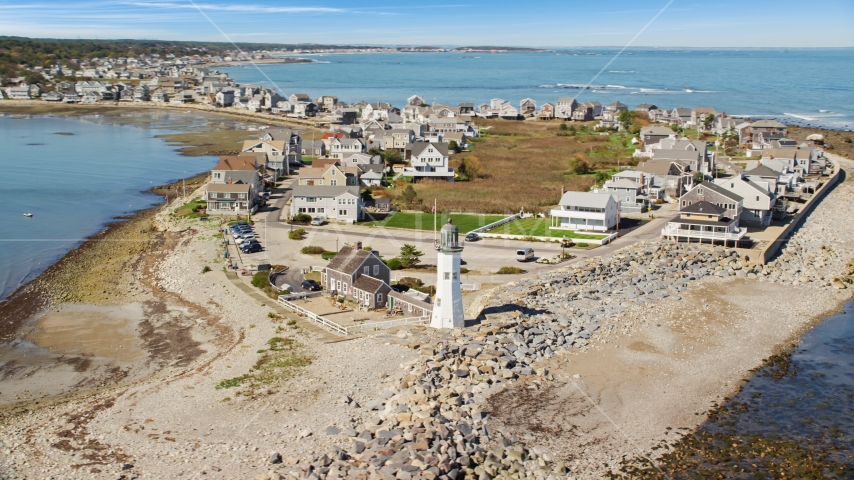 A beach, oceanfront homes, and Old Scituate Light, Scituate, Massachusetts Aerial Stock Photo AX143_041.0000204 | Axiom Images