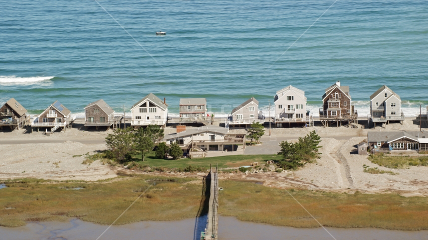 Several elevated oceanfront homes in Humarock, Massachusetts Aerial Stock Photo AX143_049.0000327 | Axiom Images